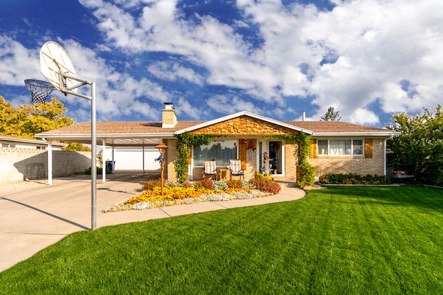 house with green lawn and basketball hoop